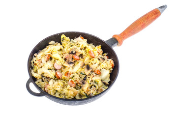Frying pan with fried cabbage, sausages and mushrooms on white background