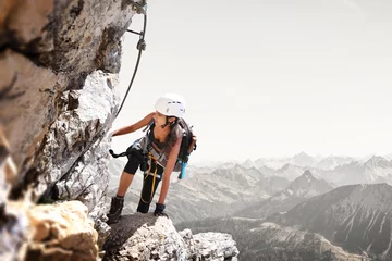 Printed kitchen splashbacks Mountaineering Fit sporty young woman mountain climbing