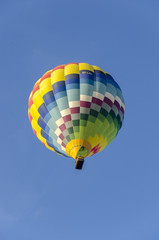 Multicolored hot air balloon seen from the ground