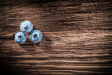 Heap of blueberries on vintage shabby board