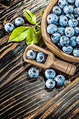 Huckleberries in wooden spoon bowl