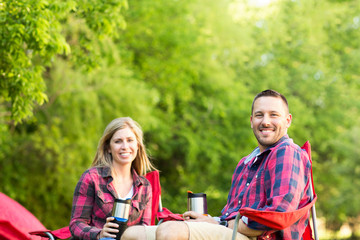 Couple talking and laughing on a camping trip.