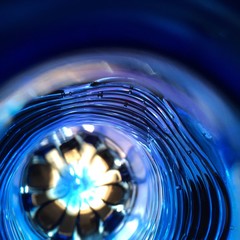 Beautiful unusual blue abstract background. The flower under the water is in the center of...