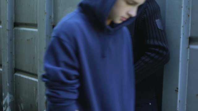 Addicted teenage boy buys pills from drug dealer, illegal trade, juvenile crime