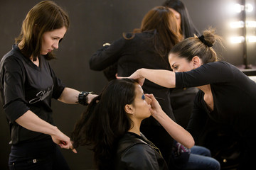 Young women doing makeup , old-fashioned. Backstage.