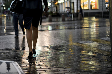 close up people walking in the city street during the heavy rain