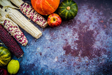corn cobs and vegetables on dark background with copy space top view © dark_blade
