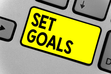 Writing note showing Set Goals. Business photo showcasing Defining or achieving something in the future based on plan Keyboard yellow key Intention computer computing reflection document.