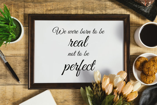 Wood frame with wisdom quote and breakfast food on rustic wood. Flat lay with text copy space.