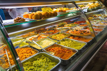 Various type of pastas, sauces and rice balls cooked and sell on aluminum tray  at the market, Mercato di San Lorenzo, in Florence, Italy