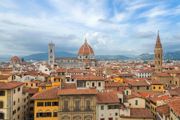 Fototapeta premium Top panoramic cityscape view of Florence, capital of Tuscany region,plenty of roof top renaissance architectures and Piazza del Duomo, Cathedral of Santa Maria del Fiore is major tourist attraction.