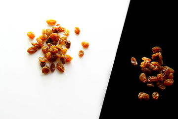 Raisins background / A raisin is a dried grape. Raisins are produced in many regions of the world and may be eaten raw or used in cooking, baking, and brewing.