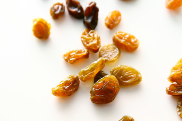 Raisins background / A raisin is a dried grape. Raisins are produced in many regions of the world and may be eaten raw or used in cooking, baking, and brewing.