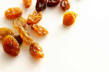 Raisins background / A raisin is a dried grape. Raisins are produced in many regions of the world and may be eaten raw or used in cooking, baking, and brewing.