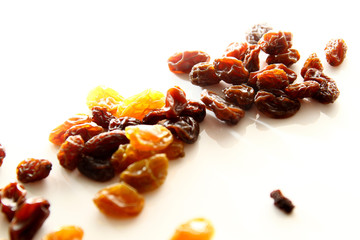Raisins background / A raisin is a dried grape. Raisins are produced in many regions of the world and may be eaten raw or used in cooking, baking, and brewing.