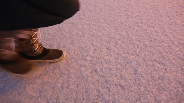 women's winter boots leave footprints in the snow.
