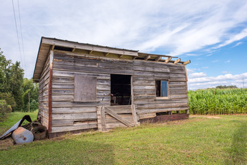 A beautiful old storage shed for farm tools and equipment by a corn field in rural, upstate South Carolina.