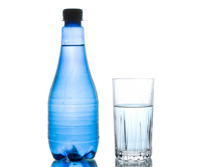 Blue water bottle isolated on white background with small water droplets and a clear drinking glass