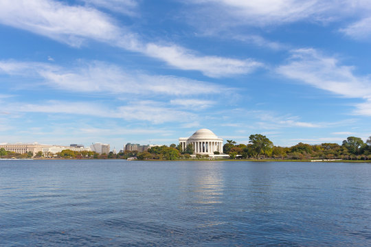 Thomas Jefferson Memorial surrounded by trees around the Tidal Basin in autumn foliage. Tidal Basin panorama in Washington DC downtown, USA.