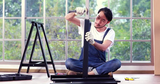 Man working on wood work, try to assembly new table, concept for diy job, do it yourself.