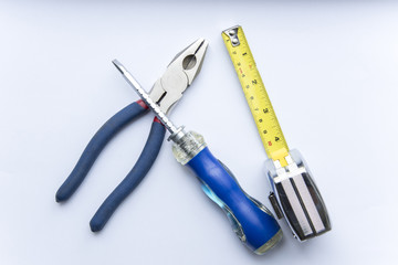 The tools on a white background. screw-driver,  meter, nippers,cutter