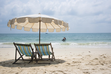 Two beach chairs on the sand beach