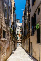 Fototapeta na wymiar Narrow Alleyway in Venice, Italy with Venetian Houses