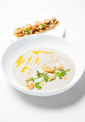 Cream mushroom soup with scallops and some herbs.