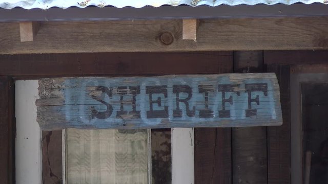 this is a sign of an old west sheriff