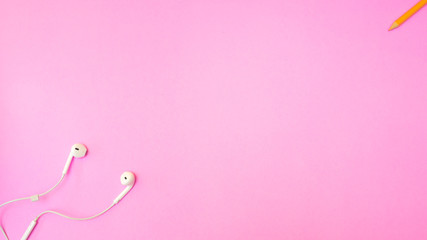 Earphone and crayon color pencil on pink  background. Pastel color Minimal concept Copy space