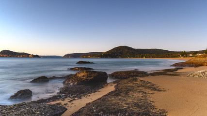 Fototapeta na wymiar Sunrise Seascape with Rocks and Clear Skies