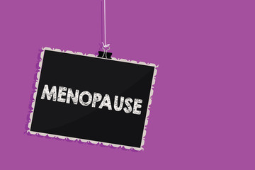 Text sign showing Menopause. Conceptual photo Period of permanent cessation or end of menstruation cycle Hanging blackboard message communication information sign purple background.