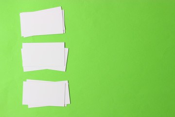  stacks of white business cards on a colored background with space for text.