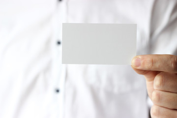 Business card in male hands, business concept.