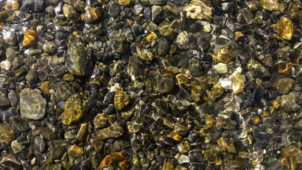 Glossy Stones in a Crystal Clear River