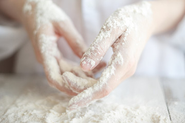 elegant female hands sprinkled with flour close-up