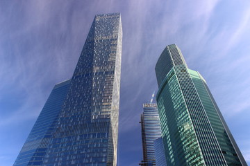 Fototapeta na wymiar Moscow, Russia, perspective view from the third ring road to the towers business center Moscow City - the shiny skyscrapers against blue sky, modern architecture