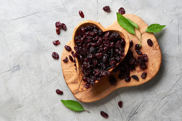 Dried cherry in a bowl over gray background. Top view.