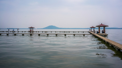Pavilion at Donghu east lake and Moshan hill in background in Wuhan Hubei China