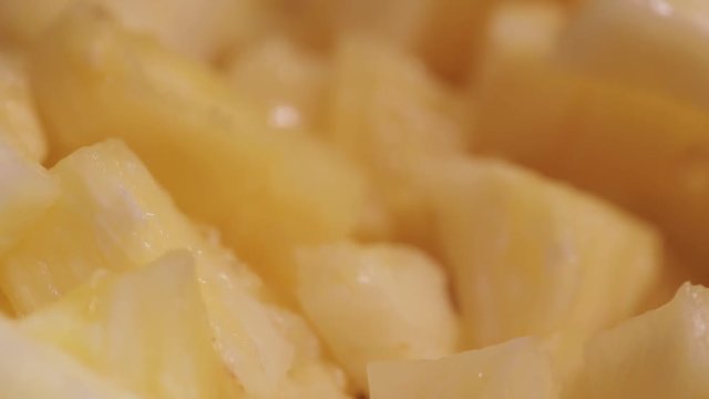 Scoop of Pine Apple pieces with a spoon. Toppings Ice cream shop