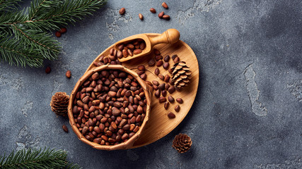 Pine nuts in bowl on gray stone table. Top view with copy space