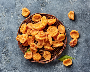 Dried apricots on gray concrete background with copy space. Top view.