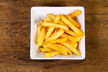 French potato over wooden background