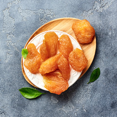 Candied sliced pear. Dried fruits on gray background. Top view.