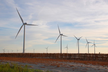 Wind turbines at sunset at a beach in Changhua, Taiwan