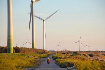 Wind turbines at sunset at a beach in Changhua, Taiwan