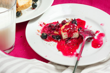 Delicious toasts bread with homemade currant jam on bright crimson tablecloth