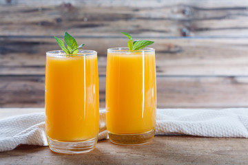 Healthy pumpkin fruit smoothie with  mint leaves on  table.