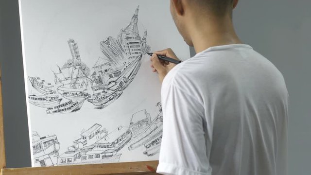 Closeup asian artist drawing black ink pen on white canvas place on easel.
