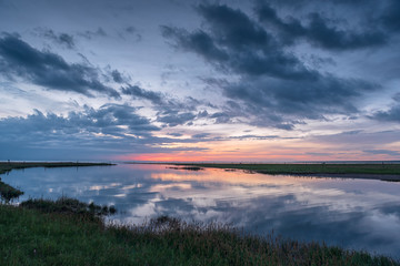 Reflection of the sun is disappearing at the end of the forest.